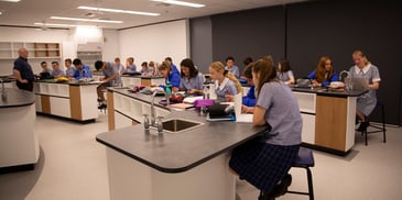 school students in a science lab with laboratory equipment